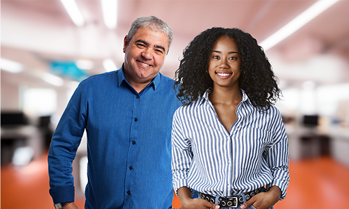 Middle age man and young woman in office