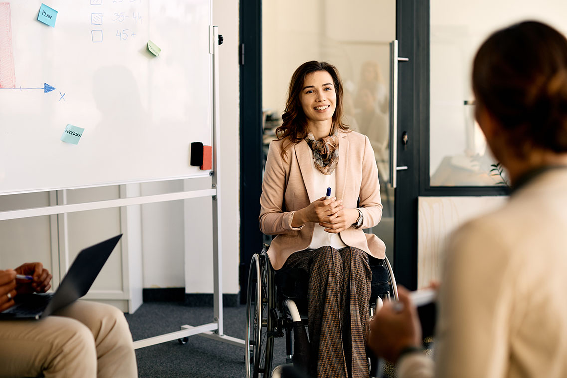 Happy wheelchair-bound businesswoman